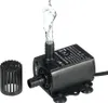 A black mini brushless DC water pump with water spraying from its outlet, shown with a separate filter attachment. Náhľad obrázku produktu