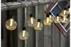 A string of decorative lights hanging from a wooden beam. Podgląd zdjęcia produktu