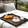 A wooden tray with breakfast items (croissants, coffee, creamer) is placed on a bed with a scenic view in the background. Anteprima dell’immagine prodotto