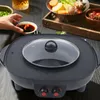 A person's hand is reaching for a dipping sauce next to a hot pot and grill. Podgląd zdjęcia produktu
