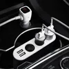 A car's interior, showing a white multi-port car charger plugged into the cigarette lighter socket. Produktbild-Vorschau