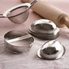 Baking tools including cookie cutters and a rolling pin on a pink surface. Anteprima dell’immagine prodotto
