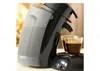 A coffee machine dispensing espresso into two glasses. Produktbild-Vorschau