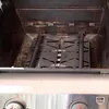 Close-up view of the inside of a grill, showing heat deflectors. Podgląd zdjęcia produktu