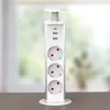A white retractable power strip with USB ports is shown on a wooden surface in front of a blurred window. Produktbild-Vorschau