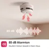 A smoke detector mounted on a ceiling, with sound waves and text indicating its alarm volume. Produktbild-Vorschau