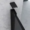 A close-up view of a black shower door frame and a detached cap against a concrete wall. Produktbild-Vorschau