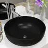 A black ceramic sink with a chrome faucet is shown on a white countertop. Podgląd zdjęcia produktu
