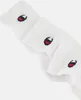 A close-up view of three white Champion crew socks with the brand's logo embroidered on them. Produktbild-Vorschau