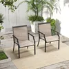 Two outdoor chairs on a patio with plants in the background. Produktbild-Vorschau
