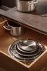 A kitchen drawer with pots and pans. Podgląd zdjęcia produktu