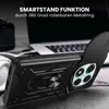 A black phone case with a ring stand and camera cover is shown on a desk next to a laptop and headphones. Produktbild-Vorschau