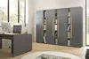An office setting with a desk and a large modular cabinet filled with books and binders. Produktbild-Vorschau