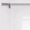 A close-up view of a curtain rod and sheer white curtains. Produktbild-Vorschau
