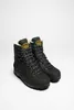 A pair of black hiking boots with green accents and white lining, presented against a plain white background. Produktbild-Vorschau