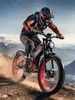 A person riding a red and black electric mountain bike on a dirt path with mountains in the background. Produktbild-Vorschau
