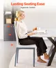 A woman is sitting on a chair at a table, holding a cup and a magazine. The chair is white with gray metal legs. Podgląd zdjęcia produktu