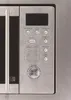 A close-up view of the control panel and handle of a microwave oven. Produktbild-Vorschau
