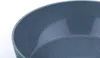 A close-up view of the interior of a green frying pan with a speckled gray non-stick coating. Produktbild-Vorschau