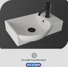 A white ceramic sink with a black faucet and drain, set against a dark gray background. Produktbild-Vorschau