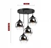 A multi-lamp pendant light fixture with glass shades. Podgląd zdjęcia produktu