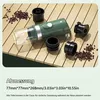 A portable espresso machine and its accessories are laid out on a wooden table, with coffee beans scattered around. Produktbild-Vorschau
