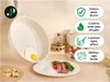 A frying pan with an egg inside, placed on a counter with food items and kitchenware. Anteprima dell’immagine prodotto