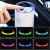 A hand pressing a button on a white air purifier with a purple light ring, with multiple smaller images showing the air purifier with different colored light rings. Produktbild-Vorschau