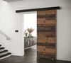 A sliding door in a hallway next to a staircase.