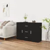 A black sideboard is placed against a white wall next to a sofa. A vase with plants is on the right side of the sideboard. Produktbild-Vorschau
