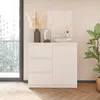 A white dresser with three drawers and a cabinet door, decorated with a vase of dried flowers, a small mirror, and books. Produktbild-Vorschau