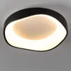 A close-up view of a modern black LED ceiling light with a white diffuser. Produktbild-Vorschau