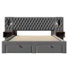 A studio shot of a grey upholstered bed frame with integrated nightstands and drawers. Produktbild-Vorschau