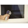 A hand holding an infrared thermometer pointed at a window. Produktbild-Vorschau