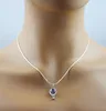 A necklace with a hot air balloon charm is displayed on a mannequin. Produktbild-Vorschau