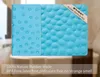 A blue bathtub mat with a pebble-like texture is shown, with text overlays describing its features. Produktbild-Vorschau