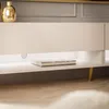 A close-up shot of a modern TV stand with a book on the shelf and LED lighting. Produktbild-Vorschau