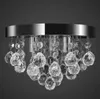 A close-up studio shot of a crystal chandelier with a chrome base against a dark gray background. Podgląd zdjęcia produktu