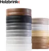 A stack of different colored and wood-patterned skirting boards. Produktbild-Vorschau