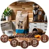 A coffee bag and beans are displayed on a wooden table in a kitchen setting, with various coffee brewing devices shown in circular icons at the bottom. Náhled obrázku produktu