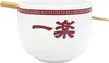 A white ramen bowl with red Japanese characters and a decorative border, with chopsticks resting on the rim. Podgląd zdjęcia produktu