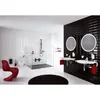 A modern bathroom with white tiled walls and black tiled accent wall, featuring a red chair, a shower, a toilet, and two sinks with round mirrors. Produktbild-Vorschau