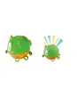 Two green and orange monster-shaped toys are displayed against a white background. The toy on the left has spikes on its back and rings on its feet. The toy on the right has colorful streamers emerging from its head and rings on its feet. Produktbild-Vorschau