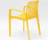 A yellow plastic chair with an intricate, web-like backrest is shown from a side-rear angle against a white background. Produktbild-Vorschau