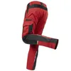 A pair of red and black work pants shown from the back with one leg bent. Produktbild-Vorschau