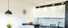 A modern kitchen interior with white cabinets, a black countertop, and a black pendant light. Anteprima dell’immagine prodotto