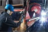 A worker is using a grinder on a large piece of machinery in an industrial setting. Produktbild-Vorschau
