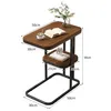 A small side table with two shelves, a cup, a book, and a plant. Produktbild-Vorschau