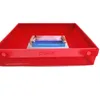 A red baking dish with a blue insert and a booklet inside. Produktbild-Vorschau