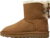 A single brown Ugg boot with a bow on the back, shown from the side against a white background. Produktbild-Vorschau